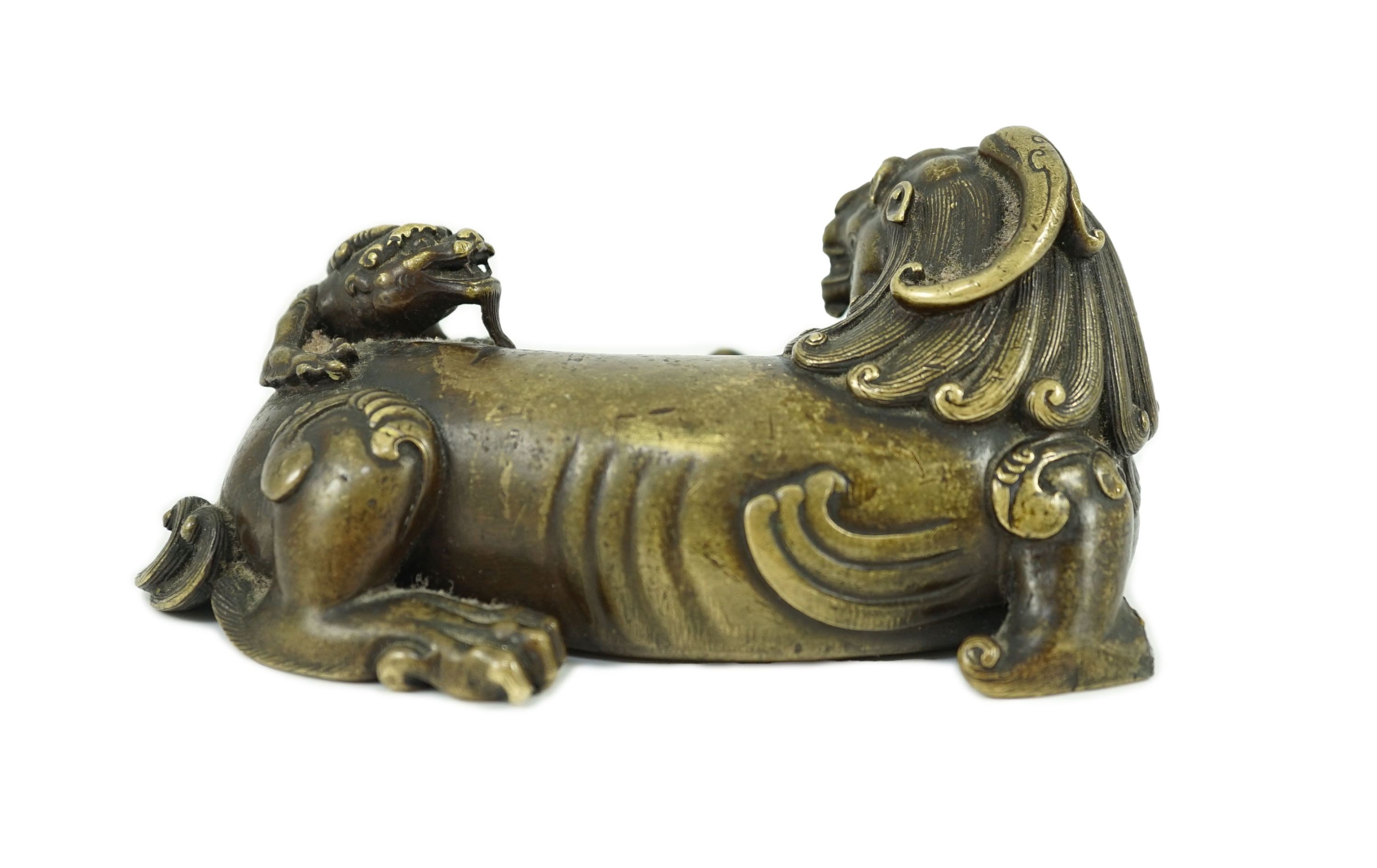 A finely cast Chinese bronze lion-dog and cub scroll weight, 17th/18th century, 14cm long, one foot and a cub lacking